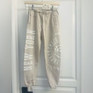 Abercrombie Kids Light Beige Joggers with White Print - Size 9/10